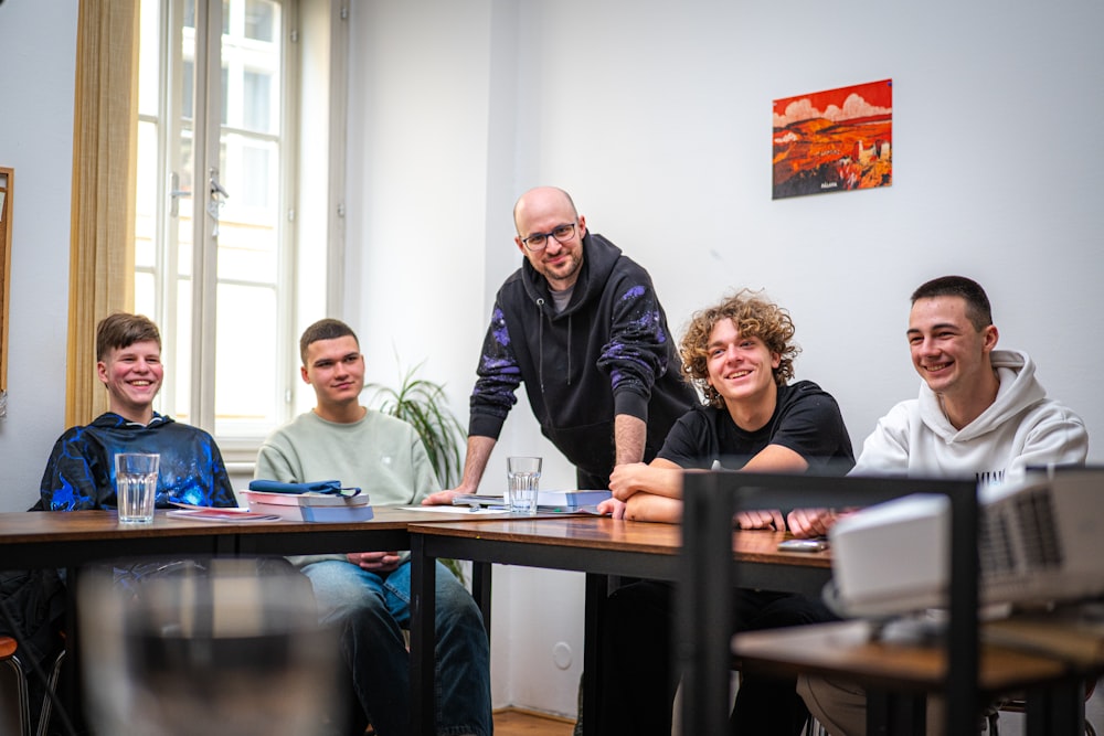 Tutor working through a lesson with a small group of smiling students